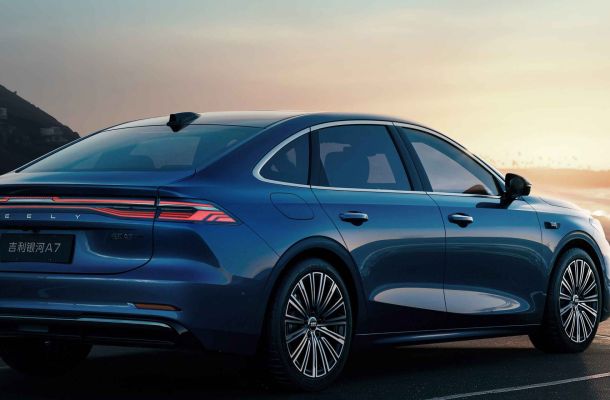 Rear and side view of the blue Geely Galaxy A7 sedan by the seaside at sunset.