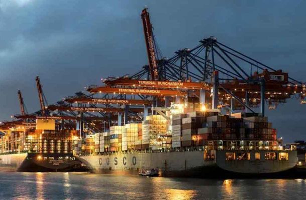 Container ships at the Terminal Burchardkai in Hamburg, Germany, during twilight.