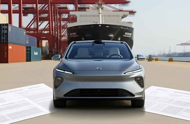 A silver electric car in a port area, with large documents spread out in front and shipping containers, cranes, and a ship in the background.