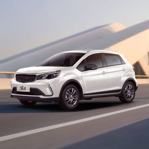 Geely Livan X3 Pro 2024 1.5L CVT XiaoSa driving A white SUV driving on a road with a modern architectural background.