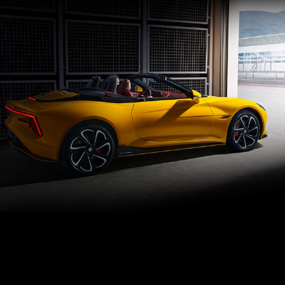 A yellow MG convertible sports car.