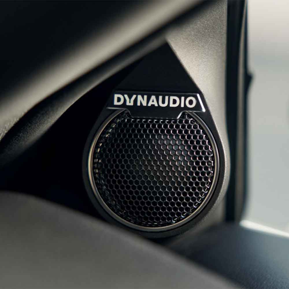 A close - up of a Dynaudio car speaker.