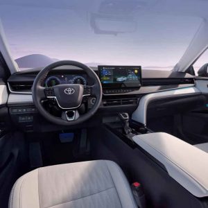 The interior of a Toyota car, showcasing the steering wheel, dashboard, and infotainment screen.