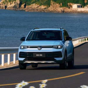 A light blue Volkswagen Tharu XR driving by the seaside
