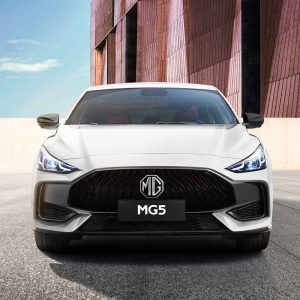 Front view of white MG5 sedan in urban setting.