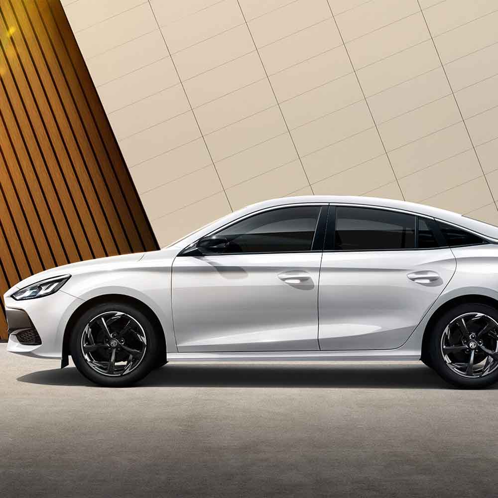 Side view of white sedan with sleek design.