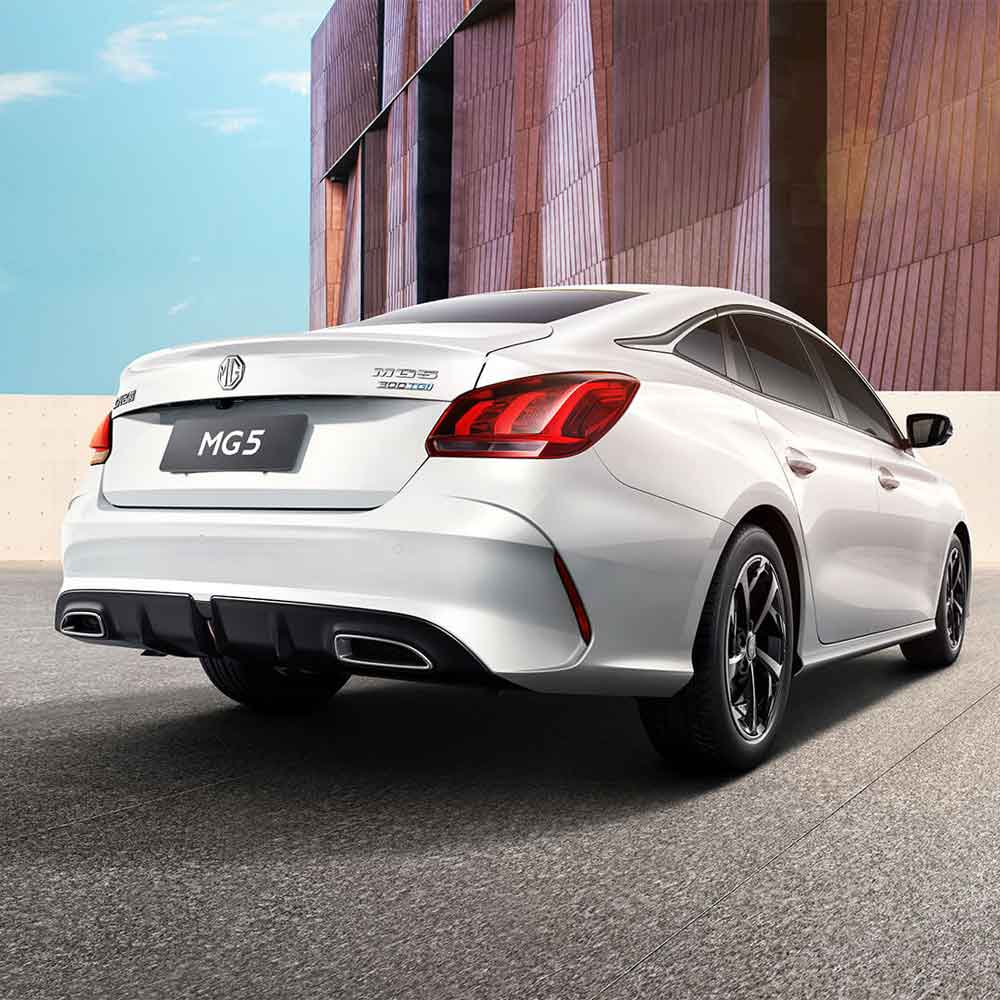 Rear view of white MG5 sedan in urban setting.