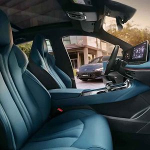 Interior of a car with blue seats, showing a modern dashboard and a view of another car outside the window.