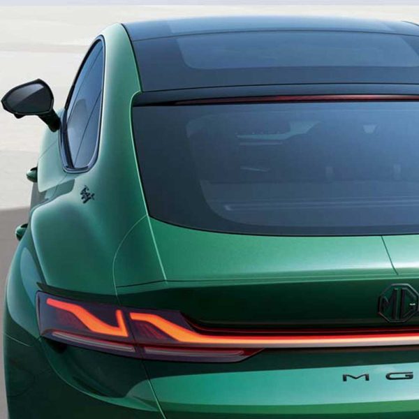 Rear view of a green MG car, showcasing its taillights and sleek design.