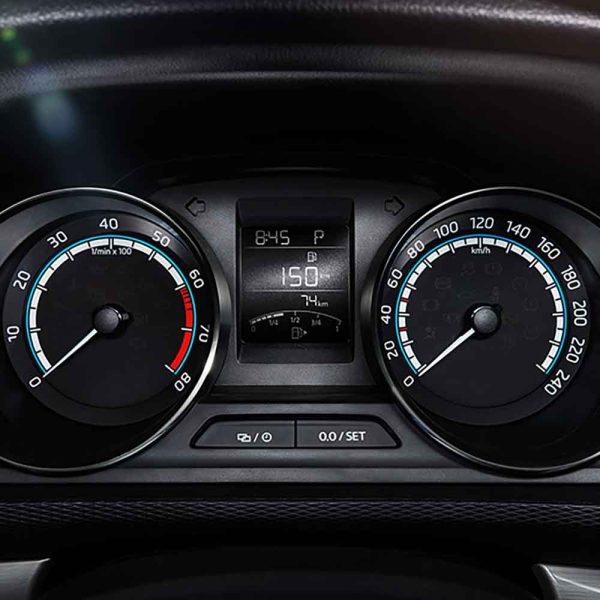 Car's instrument cluster showing speedometer, tachometer, and digital display.