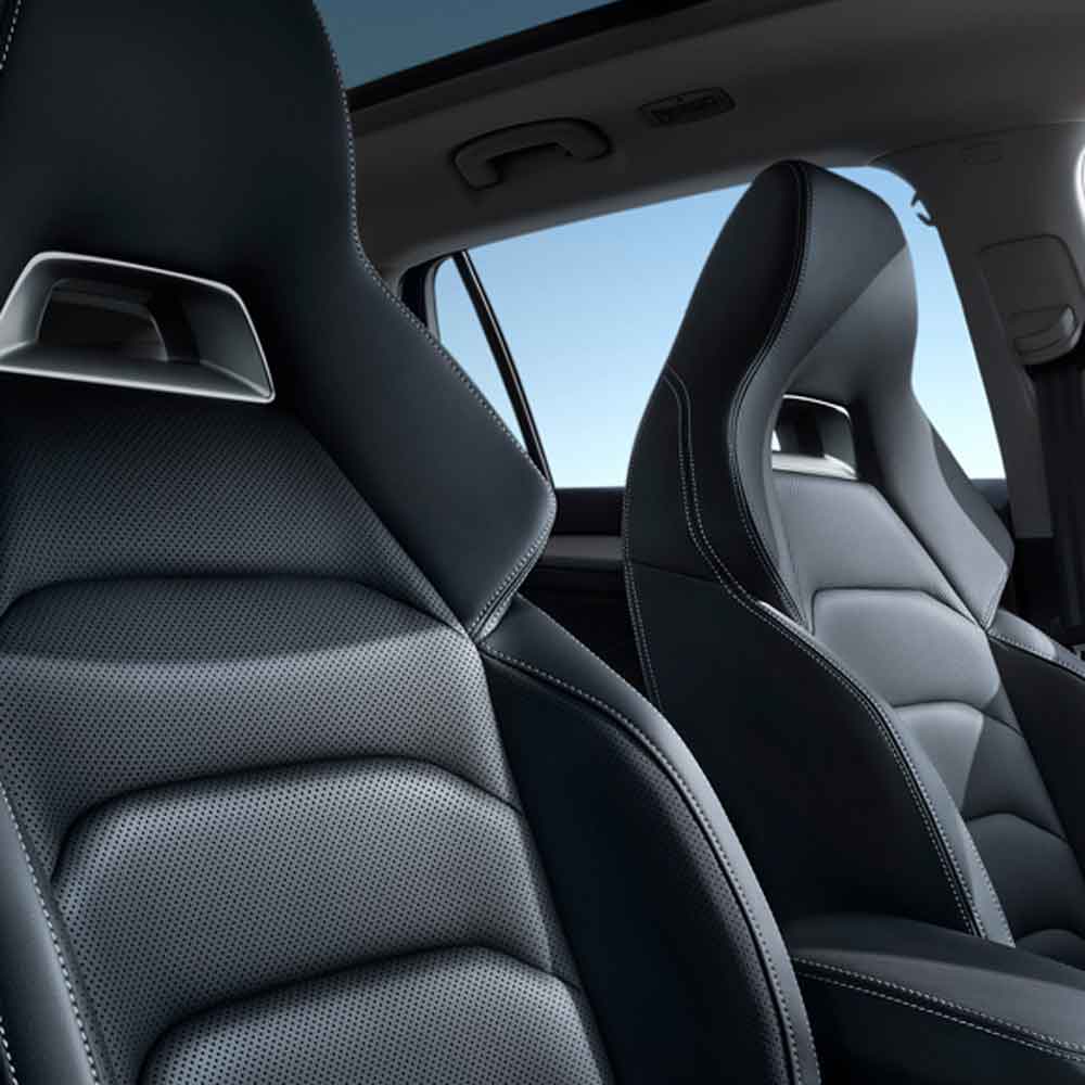 SKODA KODIAQ 2025 TSI330 5-Seater FWD Luxury Edition gallery image seats Close - up of black leather car seats with a clear blue sky visible through the car window.
