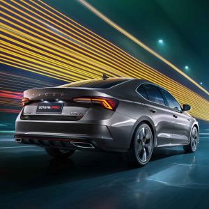 Rear view of a Skoda Octavia Pro car in motion, with dynamic light trails in the background.