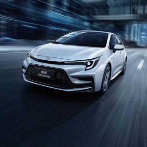 White Toyota car driving on a road with motion blur.