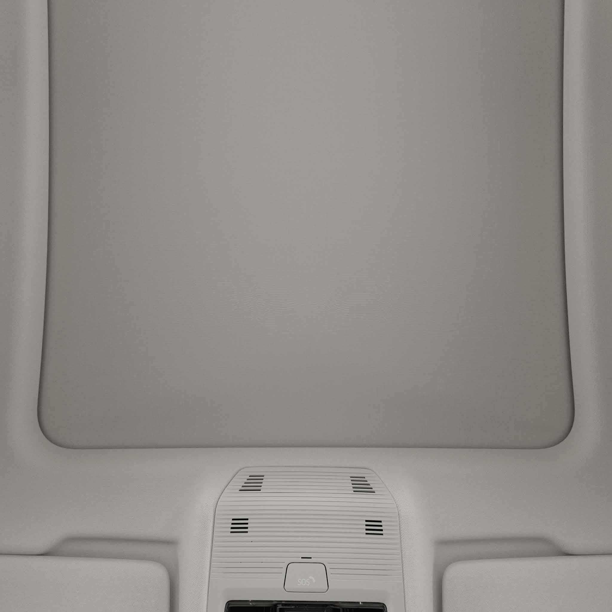 Interior view of a car's ceiling with a sunroof and control panel.
