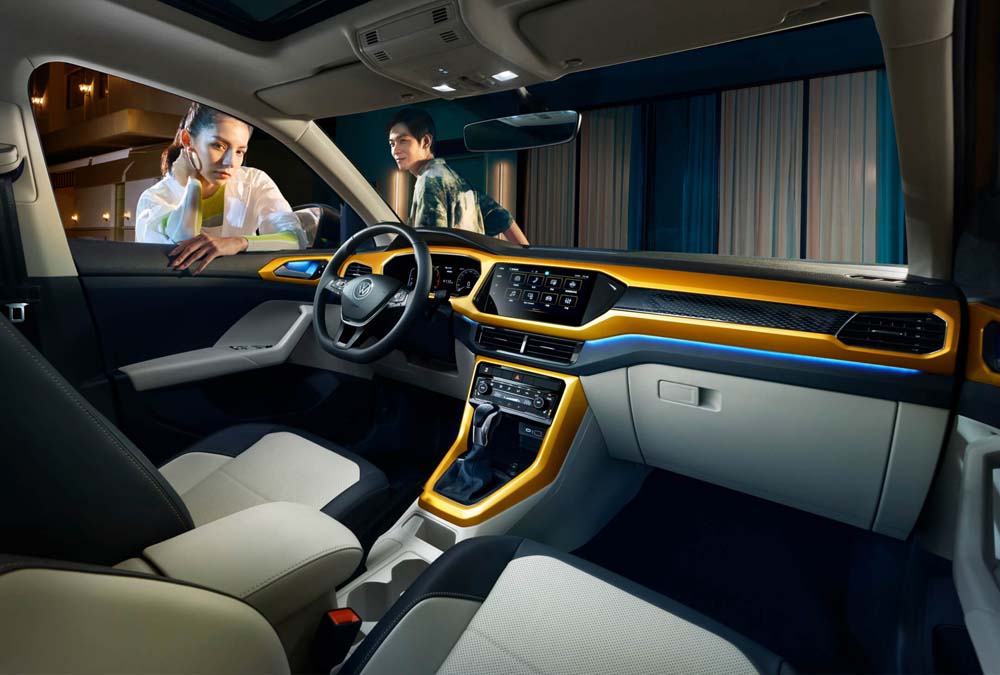 Interior of a Volkswagen car with two people interacting outside the window.