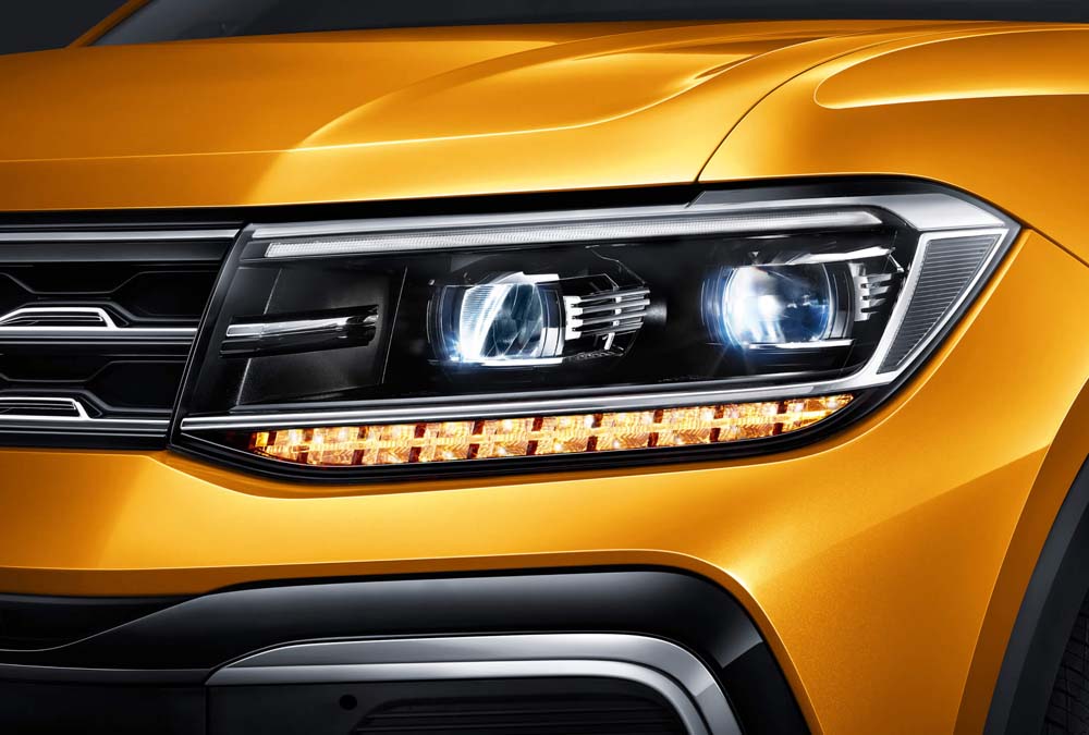 Close - up of the headlight of a yellow car.