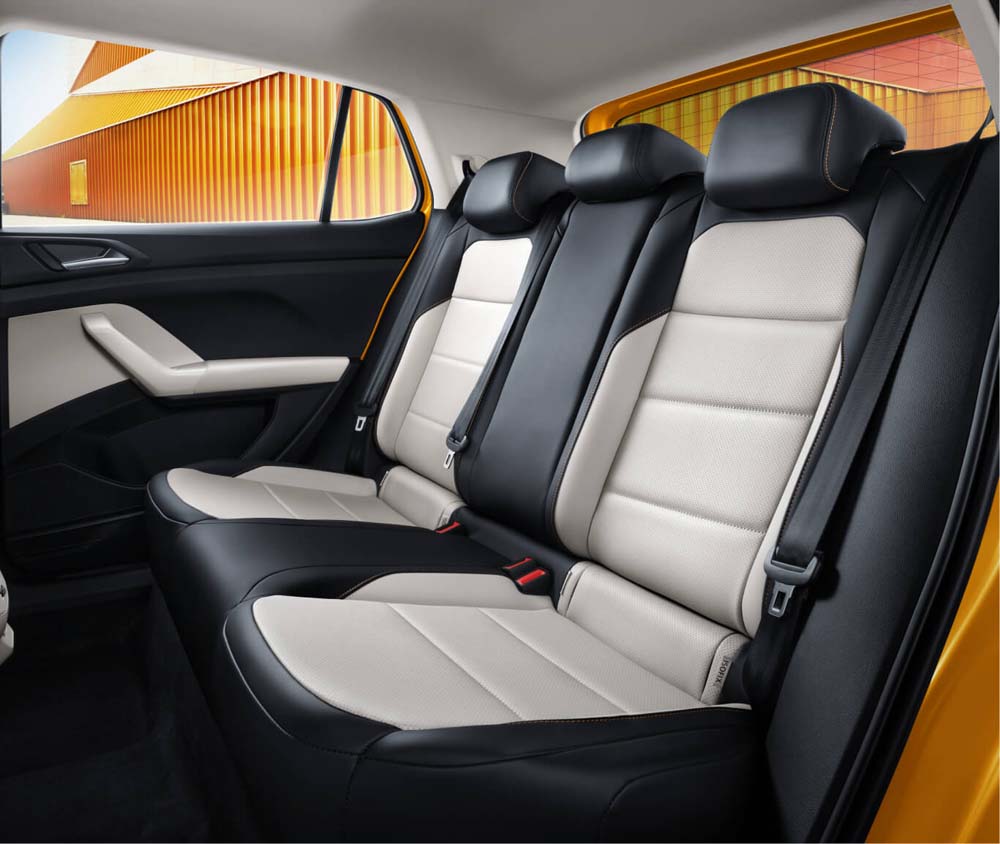 Interior view of a car's rear seats with black and beige leather upholstery.