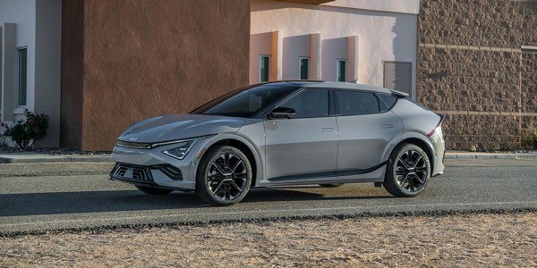 2025 Kia EV6, three quarter side view, parked on a road showcasing a newly designed silhouette