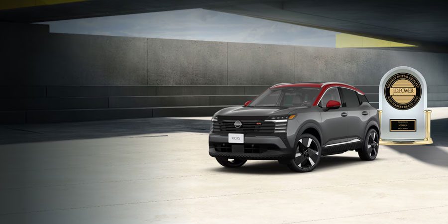 2025 Nissan Kicks in red and grey zooming through street