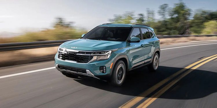A side view of a blue 2025 Kia Seltos driving on the road