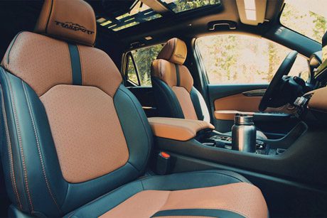 2026 Passport TrailSport Elite with brown interior, parked in alpine environment, featuring heated and ventilated front seats