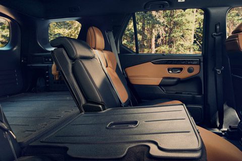 2026 Passport TrailSport Elite with brown interior, second row passenger point of view, parked in alpine environment, demonstrating seat configur