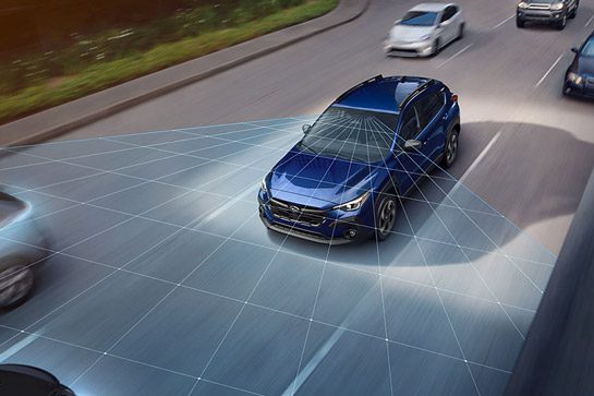 A blue 2026 Subaru Crosstrek driving on a highway