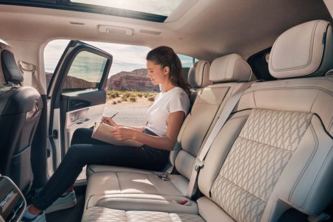 A woman sits comfortably in the spacious second row of a 2026 Lincoln Nautilus SUV
