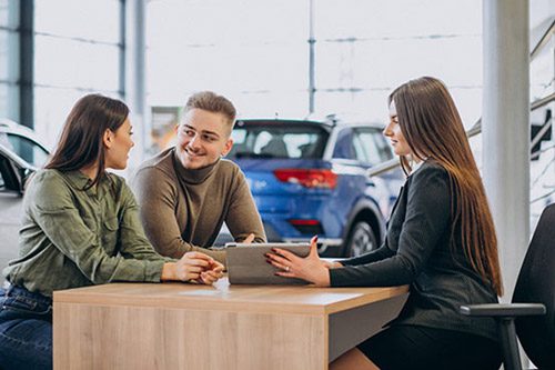Customers and car sales representatives discuss loan matters