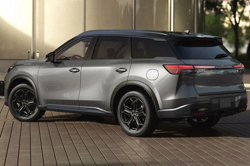 Rear three-quarter view of a 2026 INFINITI QX60 in Harbor Gray exterior
