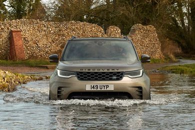 A 2026 Land Rover Discovery driving through water