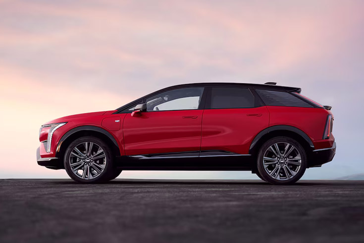 A Left Side View of a Red 2026 Cadillac OPTIQ