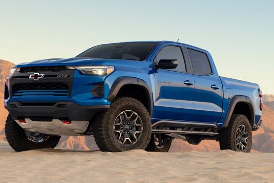 Low Angle Three Quarters View of a 2026 Blue Chevy Colorado on a Desert