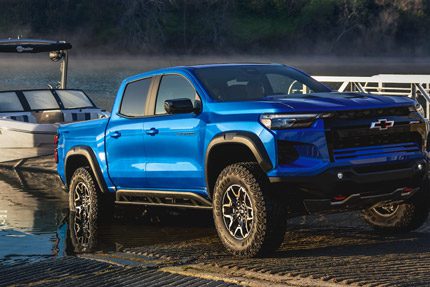 Three Quarters View of a 2026 Chevy Colorado Pickup Truck Pulling a Speed Boat to Shore