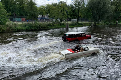 Two cars moving forward in deep water