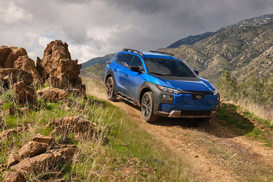 A 2026 Subaru Trailseeker in blue drives down an arid hill