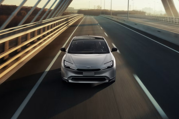A 2026 Toyota Prius drives on an elevated highway