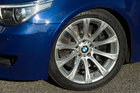 Close-up of the front wheels of a 2005 BMW M5 E60