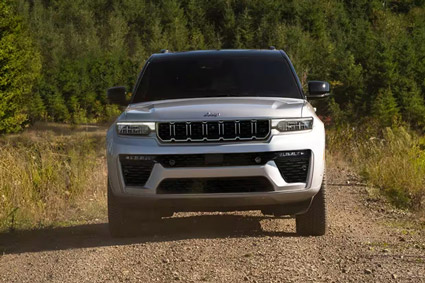 A gray 2026 Jeep Grand Cherokee L Summit traveling down a coastal highway